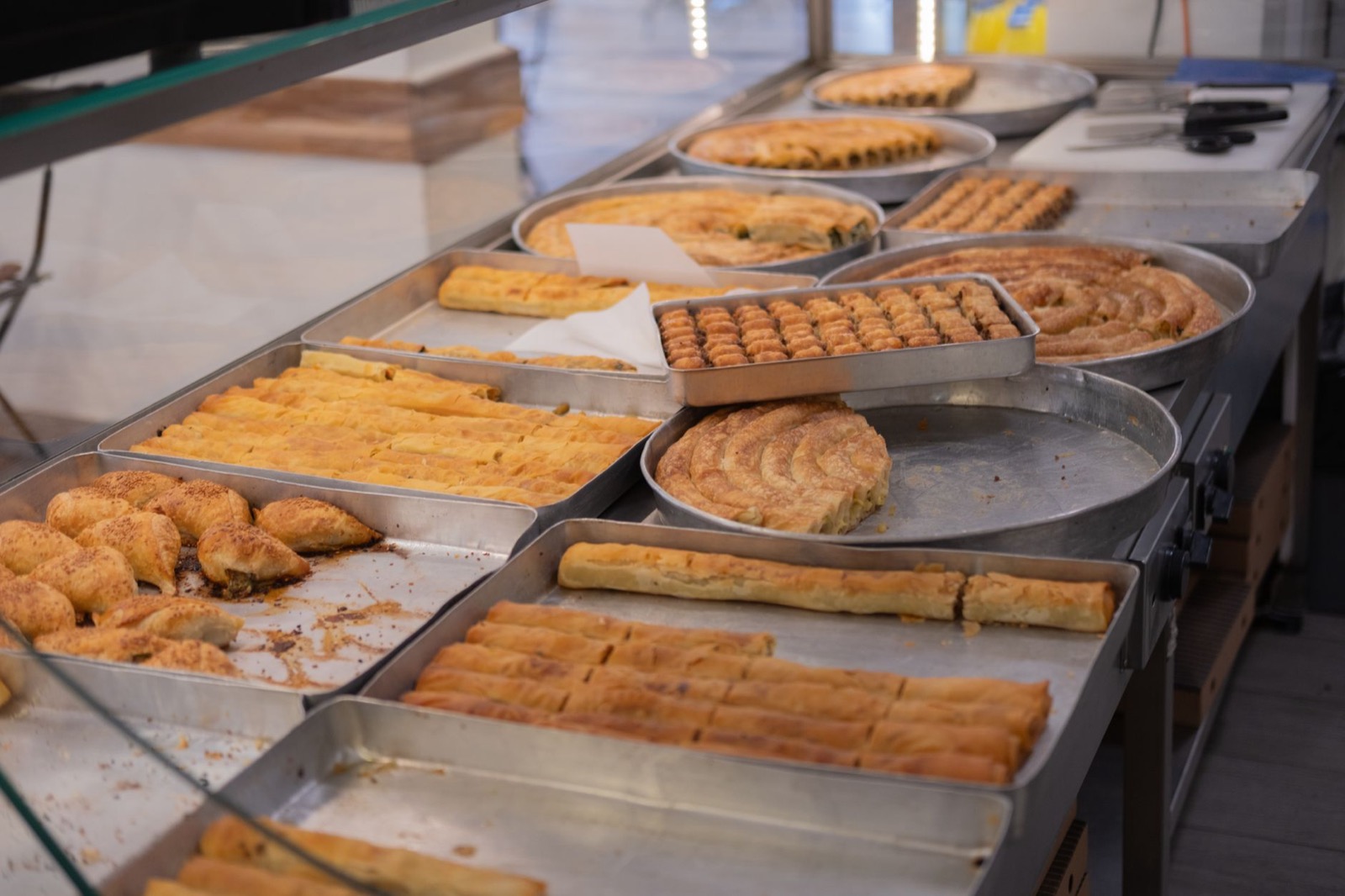 Trays of freshly baked filled pastry on a bakery counter