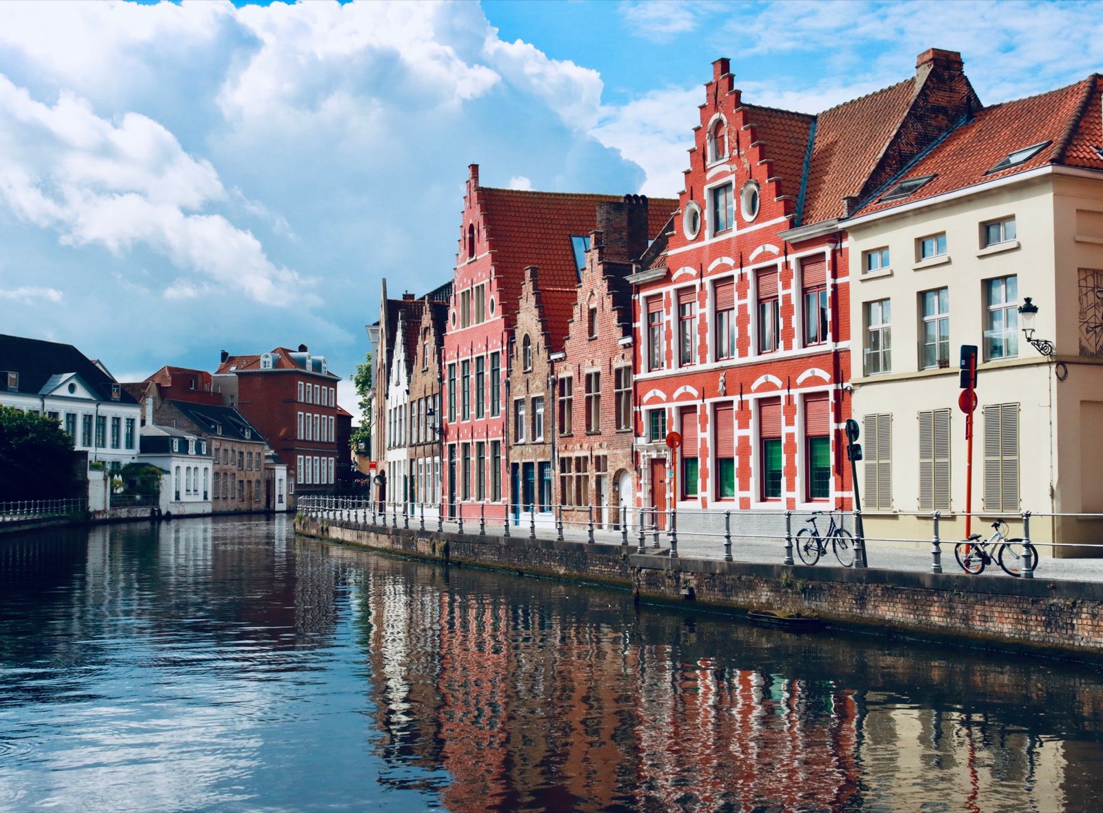Medieval brick gable houses reflected in a canal in Bruges