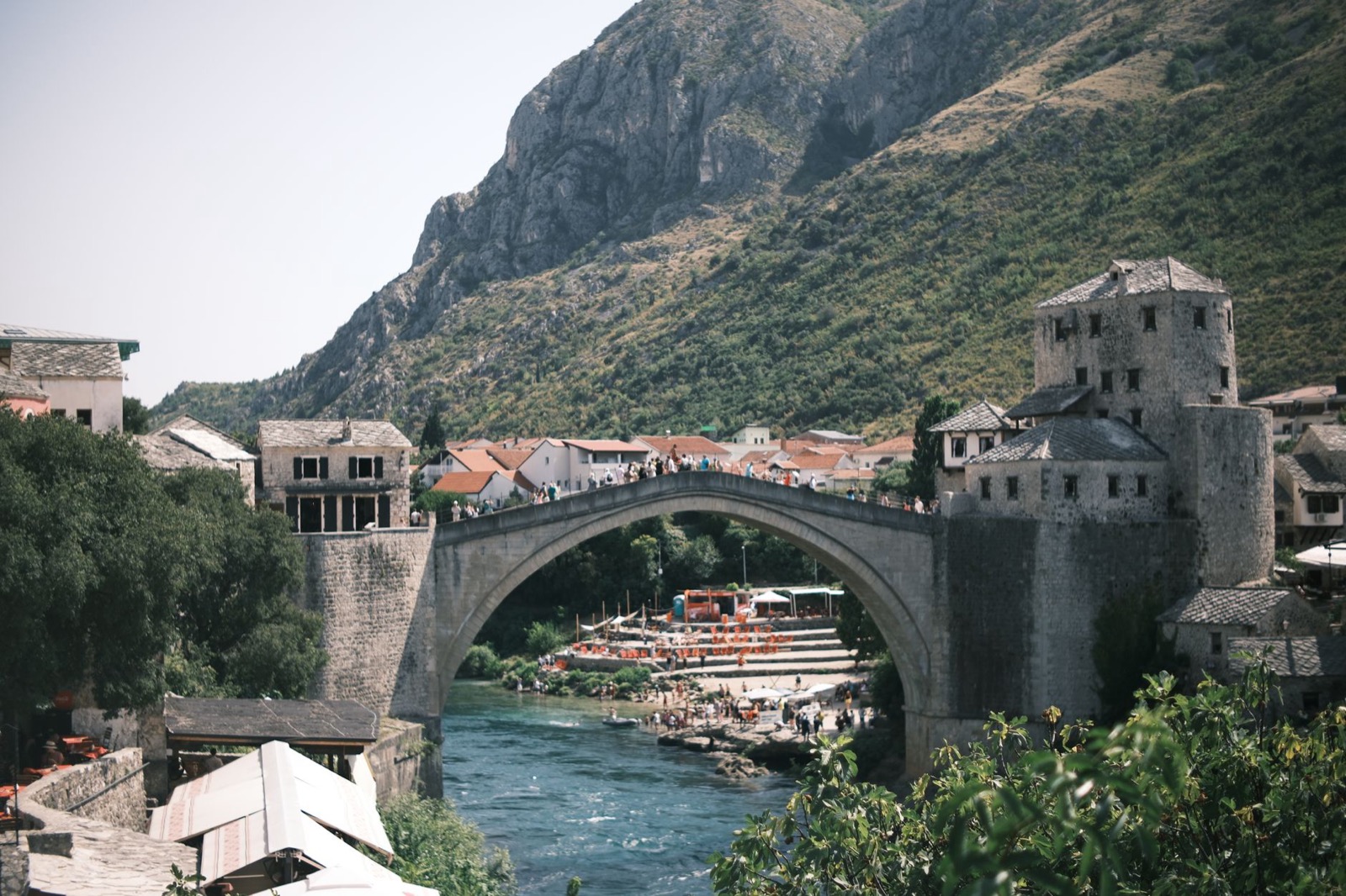 The single stone arch of the Old Bridge at Mostar over the green Neretva river