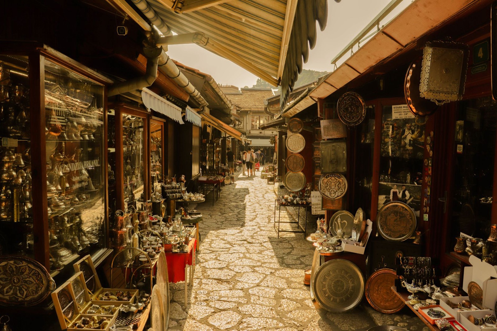 Coppersmiths' stalls and low wooden shopfronts in the Bascarsija quarter of Sarajevo