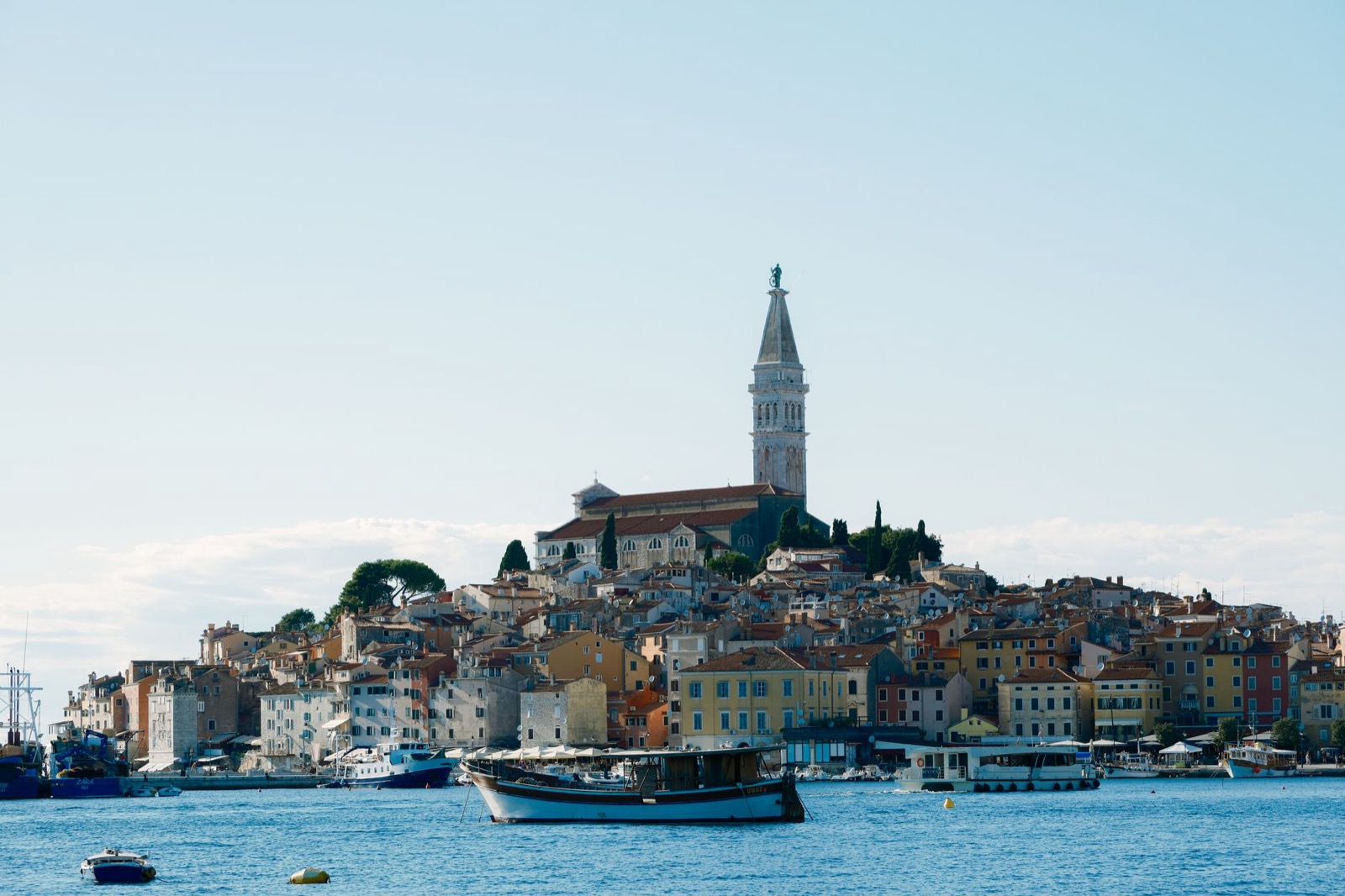 The old town of Rovinj rising from the sea with its bell tower above terracotta roofs