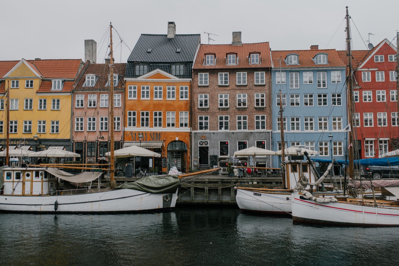Painted merchant houses and wooden boats along the Nyhavn canal in Copenhagen