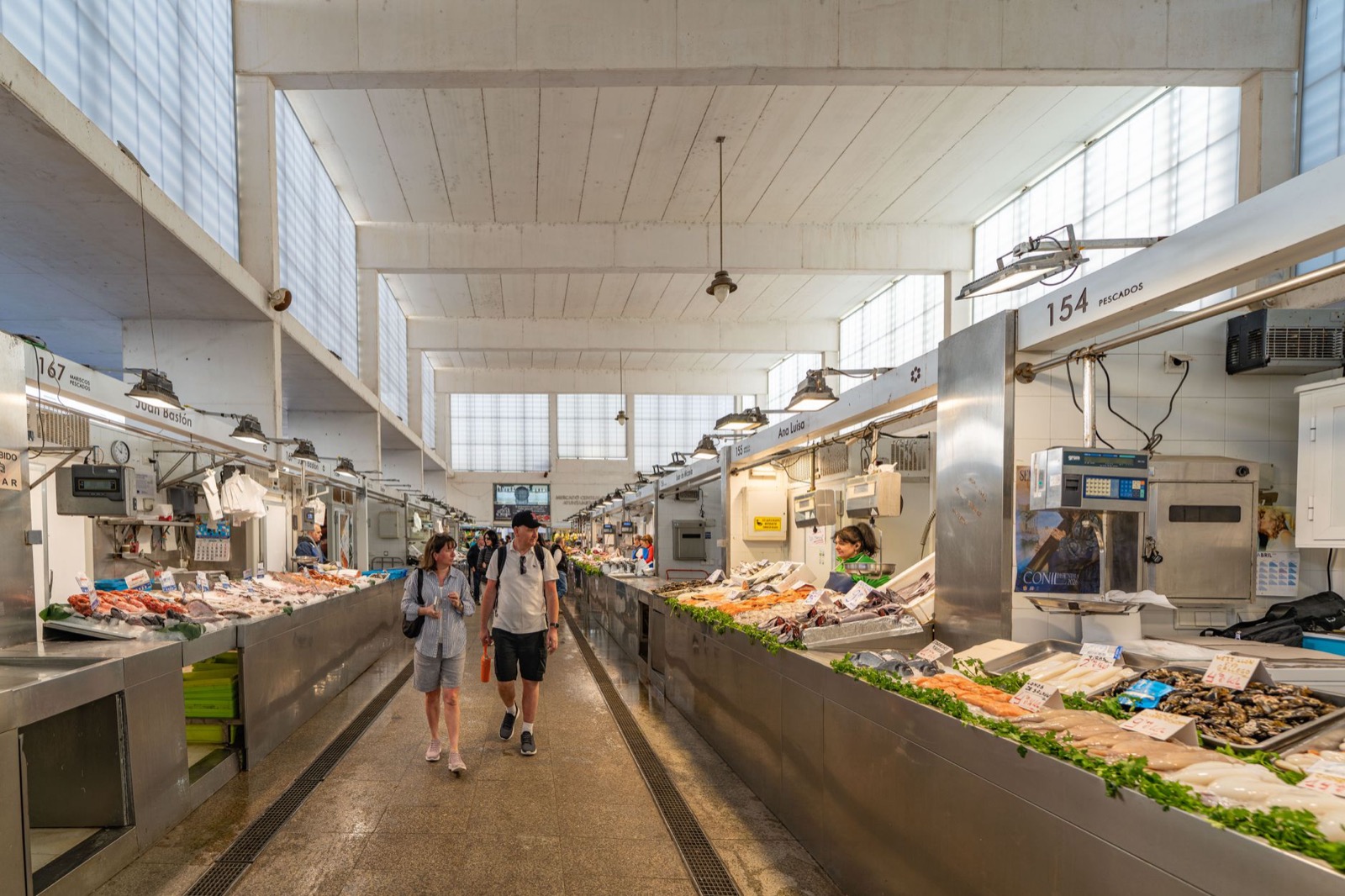 Fish and shellfish counters running down the aisle of a covered market hall