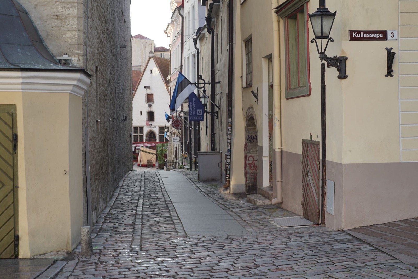 A narrow cobbled street of pastel merchant houses in Tallinn old town
