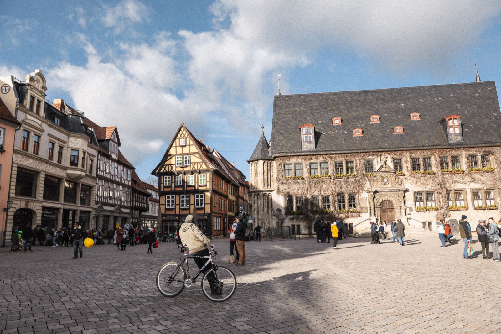A half-timbered German market square with a town hall and flower boxes