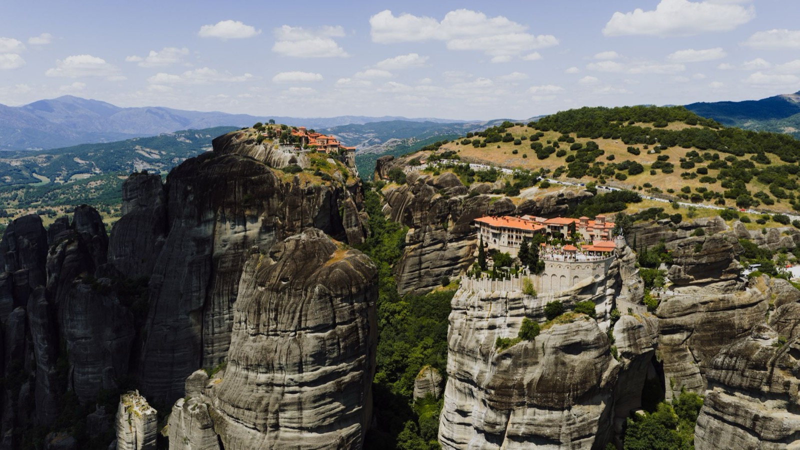 A monastery on a sheer rock pillar at Meteora with the Thessaly plain behind