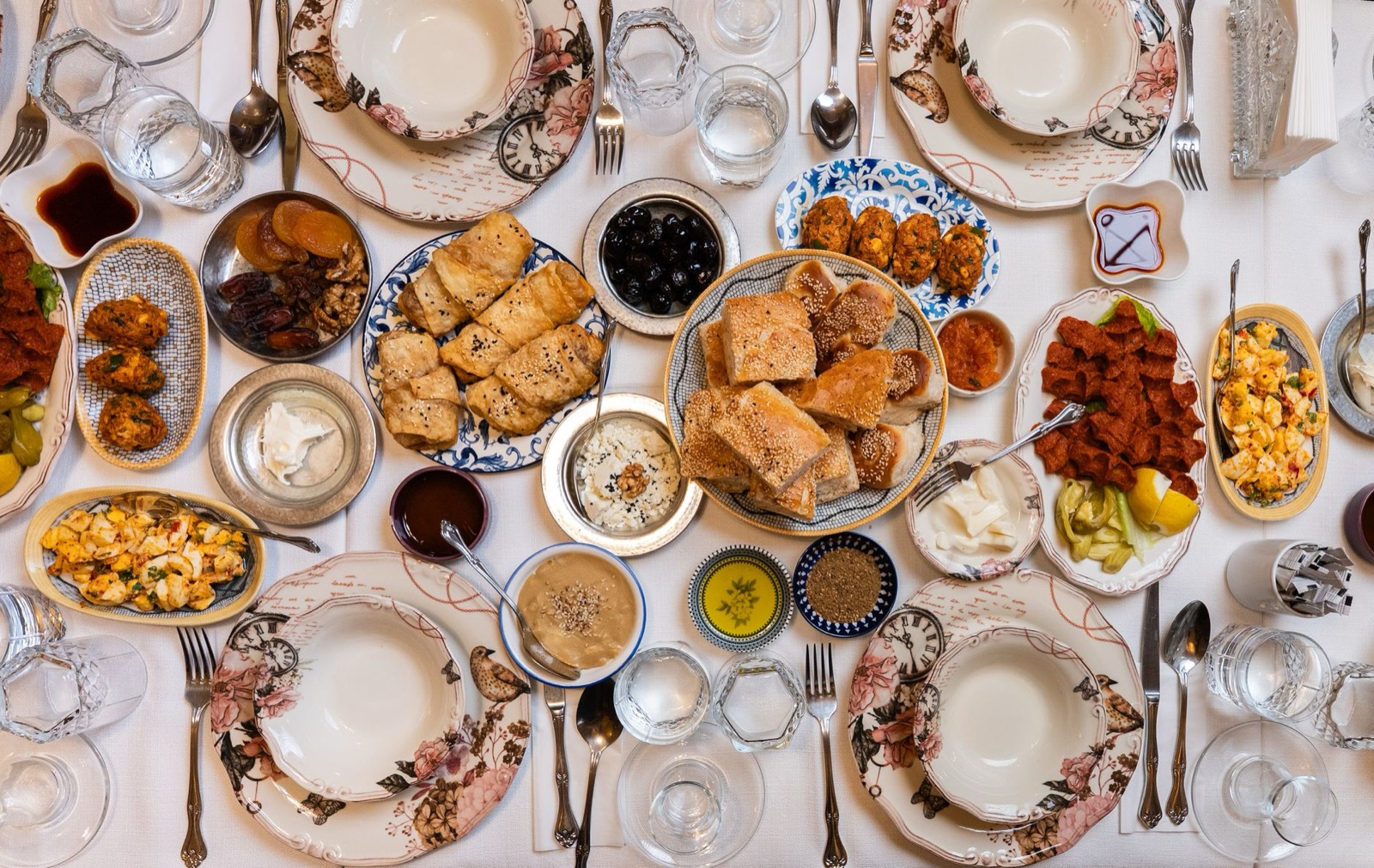 Small plates of Greek meze, bread and olives on a taverna table