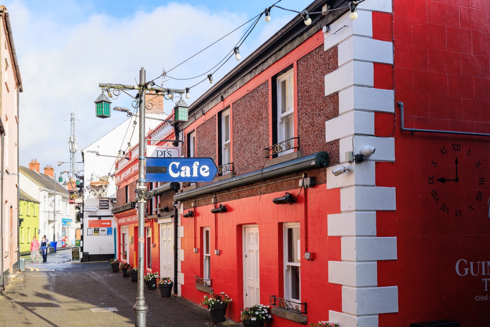 A painted pub front on a narrow street in an Irish village