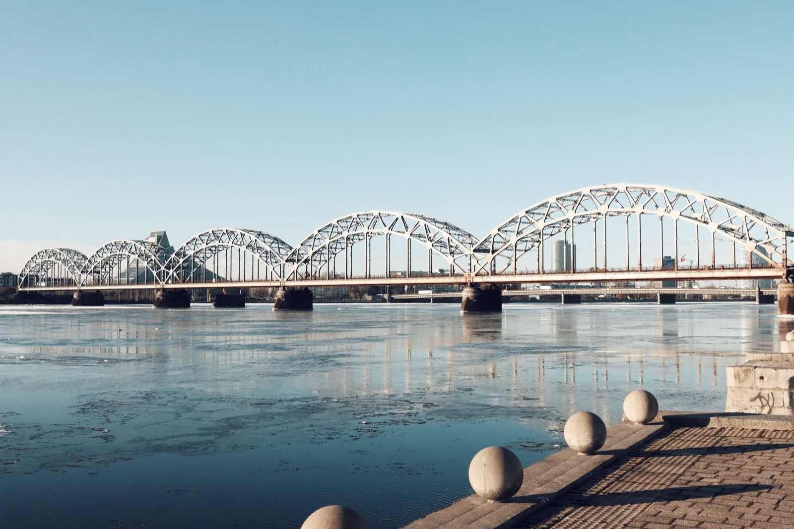 The steel arches of the Riga railway bridge over a part-frozen Daugava