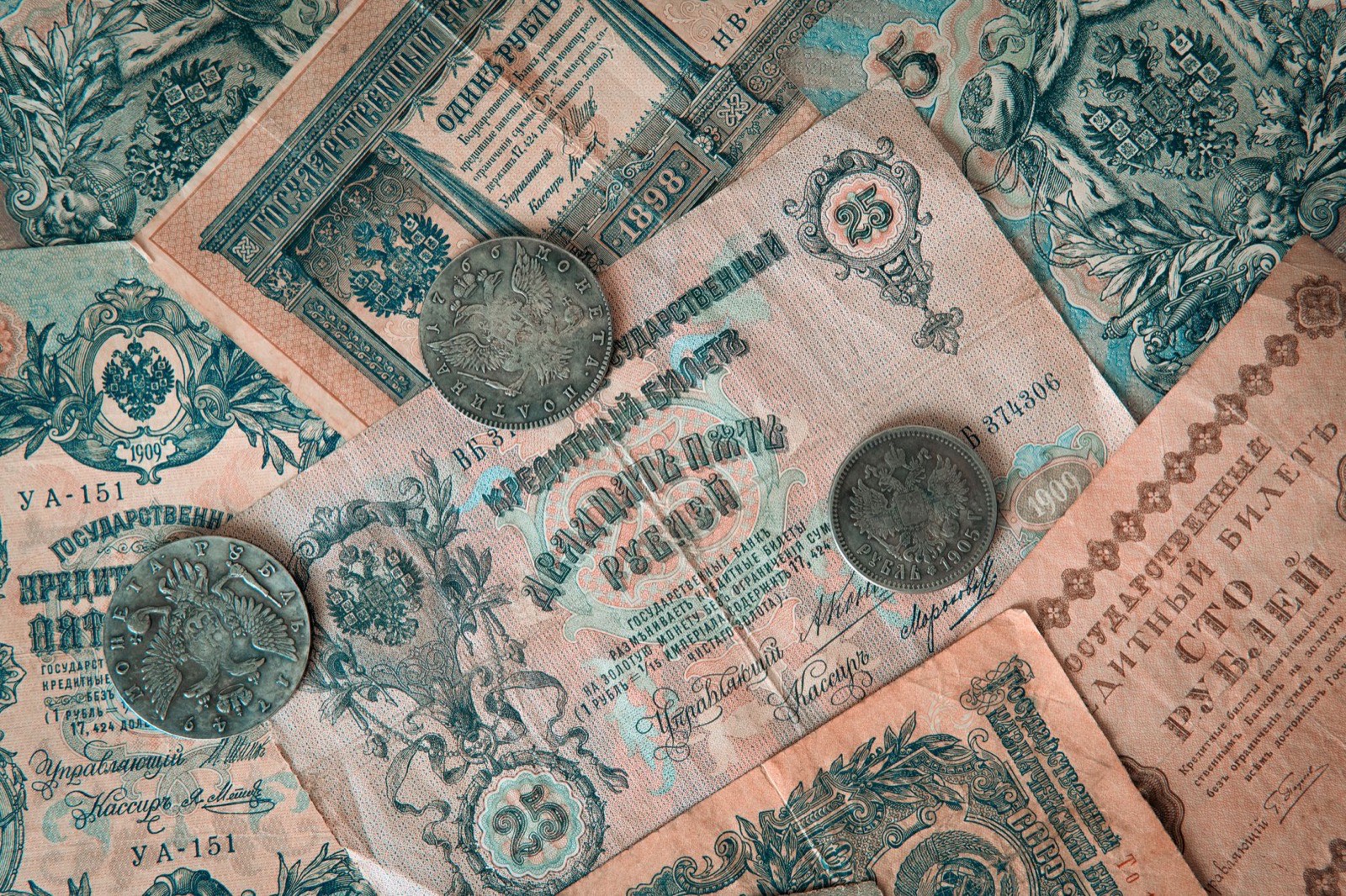 Swiss franc banknotes and coins spread on a wooden surface
