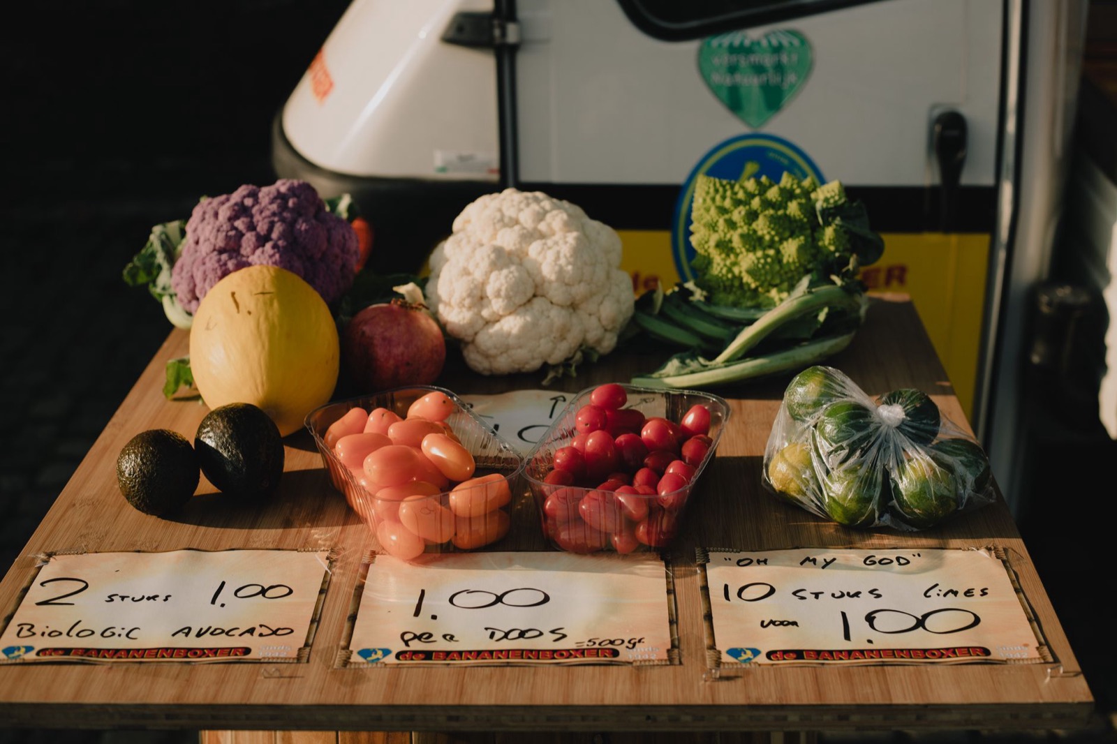 A Dutch open air market stall stacked with fruit and vegetables