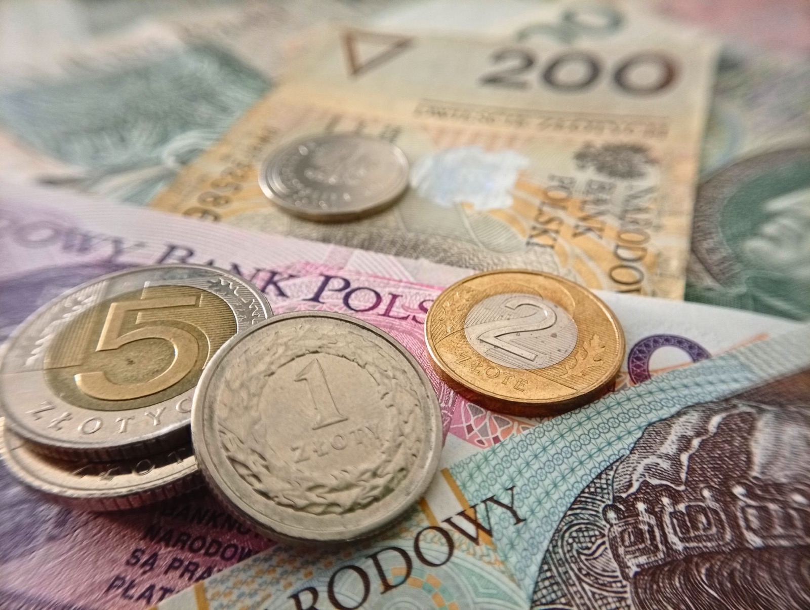 Polish złoty banknotes and coins laid out on a table