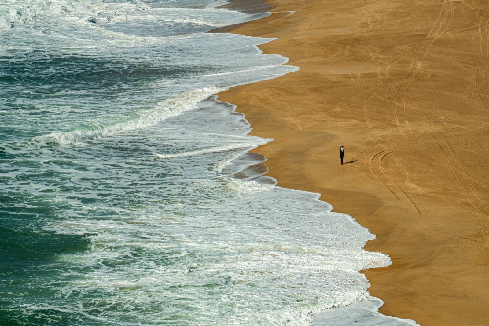 Atlantic surf breaking onto a wide Portuguese beach