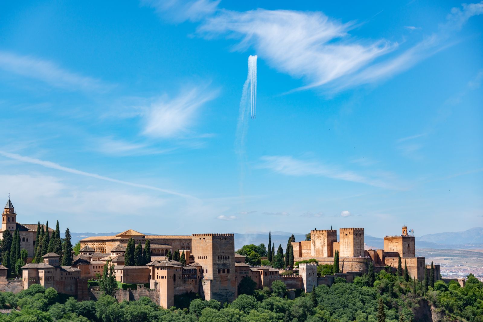The Alhambra on its wooded ridge in Granada