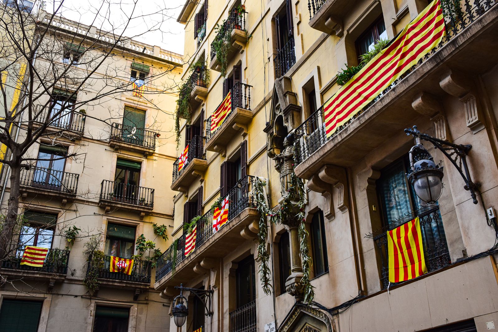 Balconies hung with Catalan flags on a narrow street in Catalonia