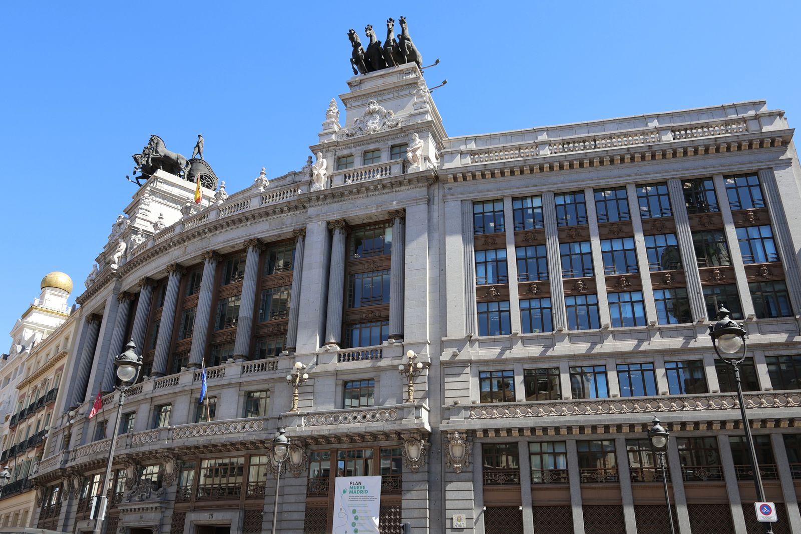A grand stone building on a Madrid boulevard