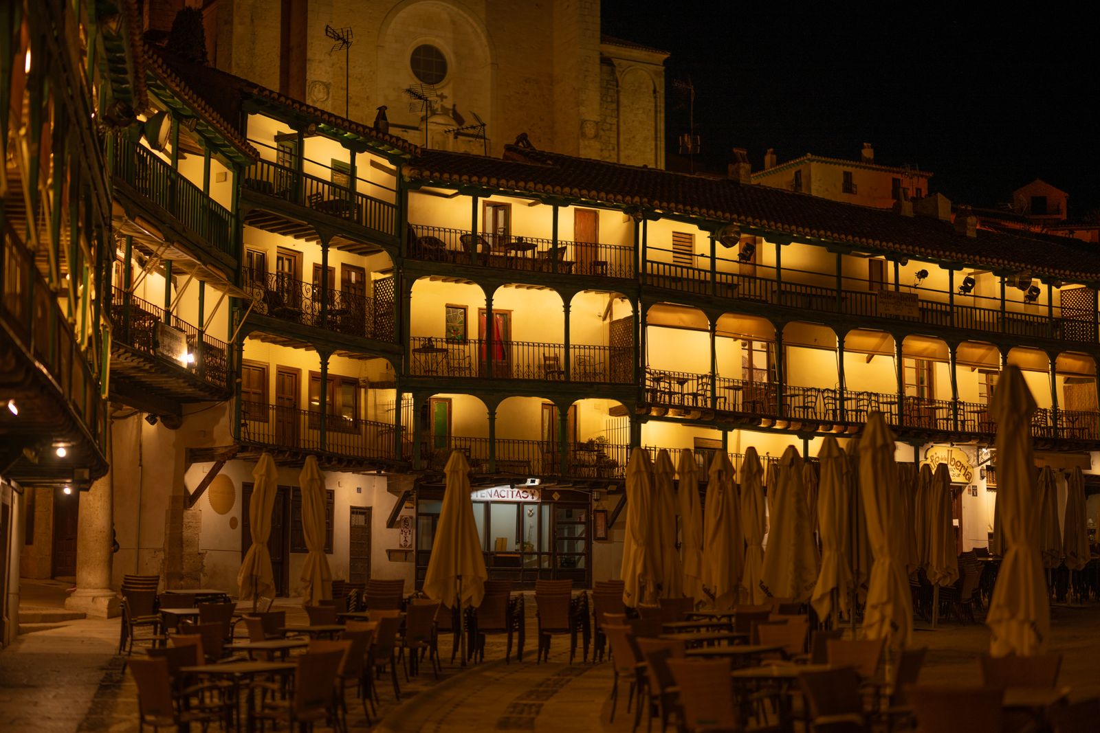 A well-lit Spanish town square at night