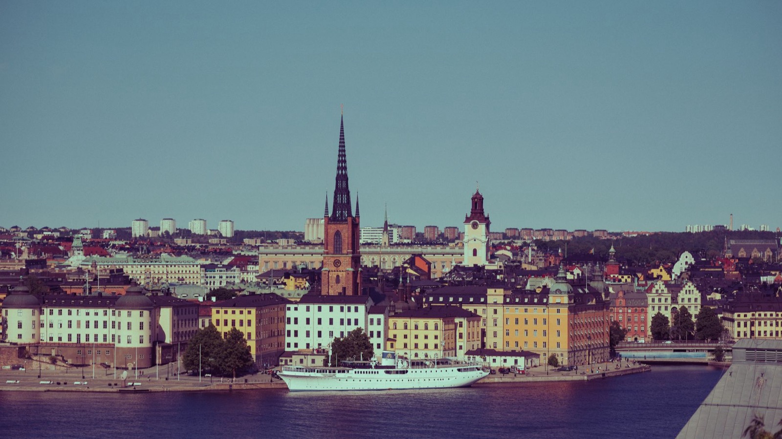The spire of Riddarholmen church above the waterfront facades of central Stockholm