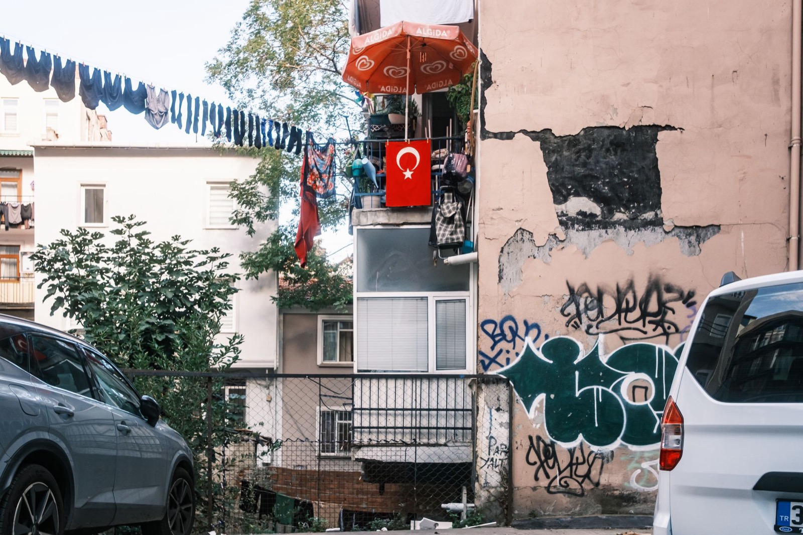 Turkish flags strung above a narrow street of old houses