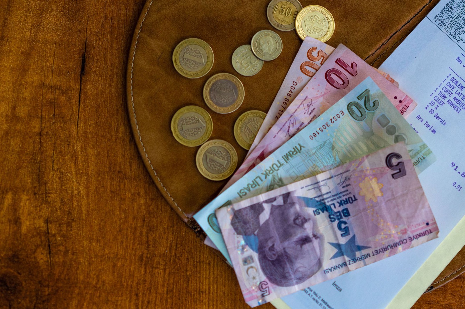 Turkish lira banknotes fanned out on a wooden surface